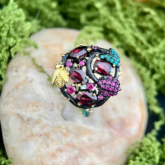 Bee & Bloom: Garnet Garden Cocktail Ring in Black Gold - Plated Silver