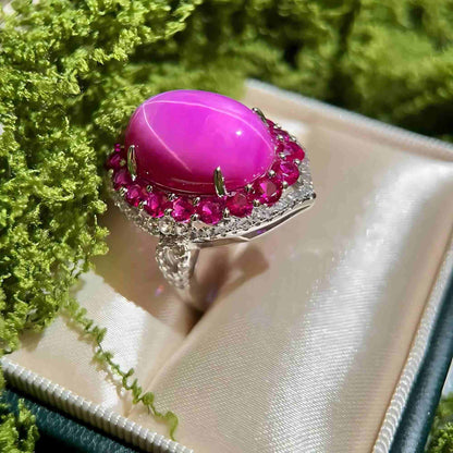 Twilight Flame: Oval Cabochon Lab - Grown Ruby Ring with Pink CZ Halo - Sound of Flowers